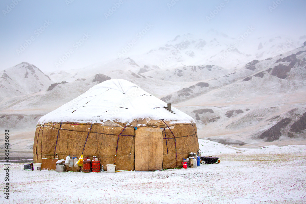 Yurts in winter. National ancient house of the peoples of Kyrgyzstan and Asian countries. national housing. Yurts against the backdrop of snow and highlands. Yurt camp for tourists. Yurts in winter. National ancient house of the peoples of Kyrgyzstan and Asian countries. national housing. Yurts against the backdrop of snow and highlands. Yurt camp for tourists.