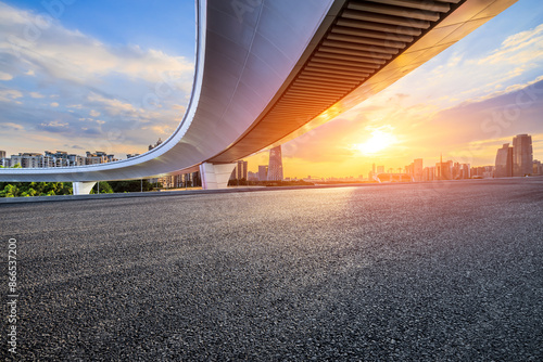 Asphalt highway road and bridge with modern city buildings scenery at sunset. car background. photo