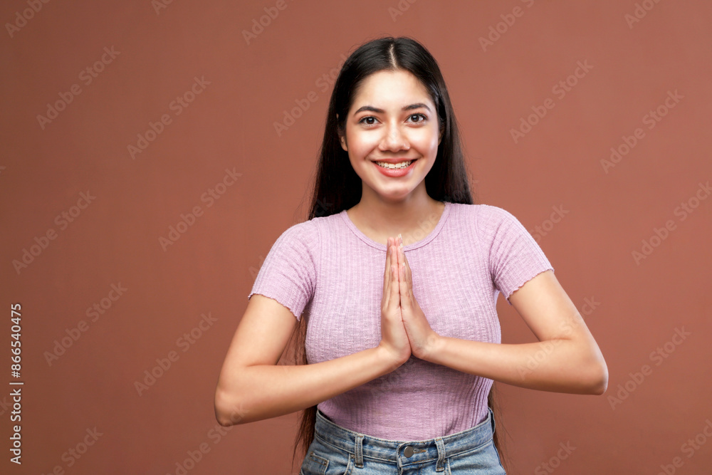 Obraz premium A Beautiful Woman Showing Namaste Hand Sign And Looking Peaceful
