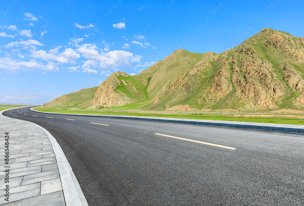 Naklejka premium Asphalt highway road and mountain nature landscape under blue sky. car background.