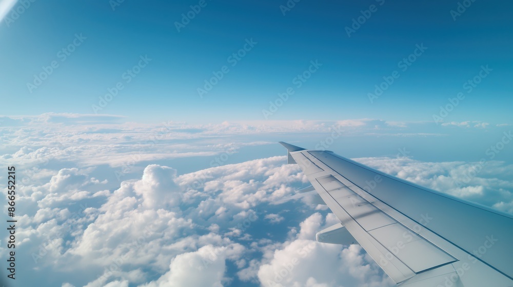 Airplane wing with a view of the clouds, in-flight experience, travel perspective Airplane wing with a view of the clouds, in-flight experience, travel perspective