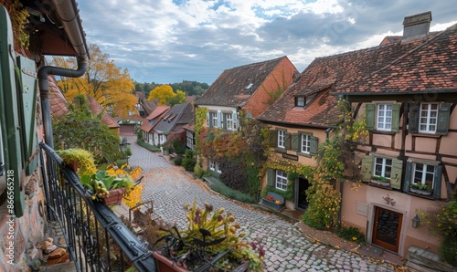 Fototapeta Naklejka Na Ścianę i Meble -  A quaint village with cobblestone streets and historic buildings, viewed from a balcony of a charming inn
