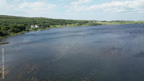 river snizort aerial panning shot scotland windy day waves water sunshine green grass  photo