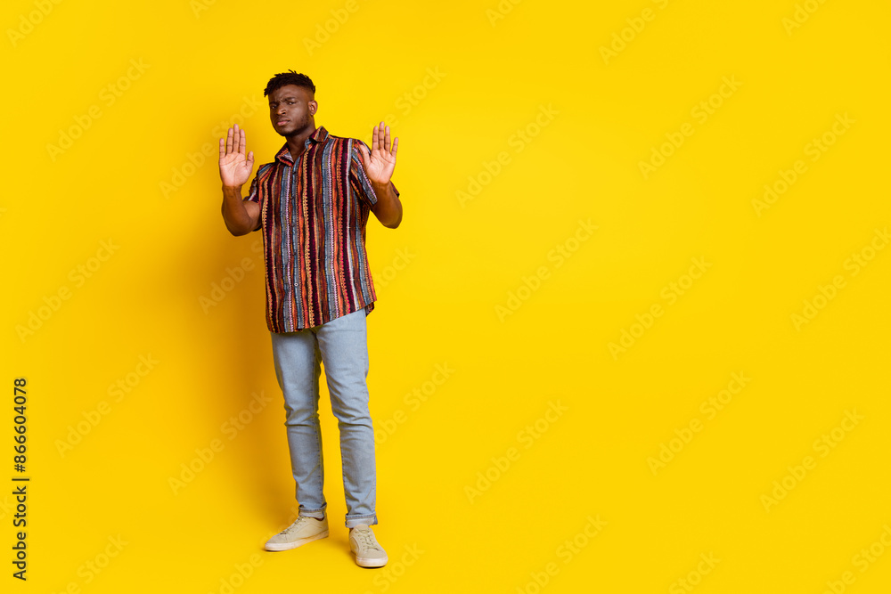 Full size photo of nice young man arms show stop enough empty space wear shirt isolated on yellow color background Full size photo of nice young man arms show stop enough empty space wear shirt isolated on yellow color background