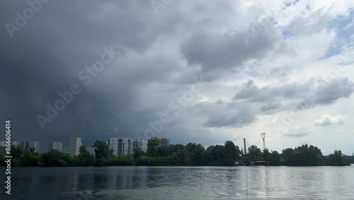 Dark and light sky in the same time, over the river in summer