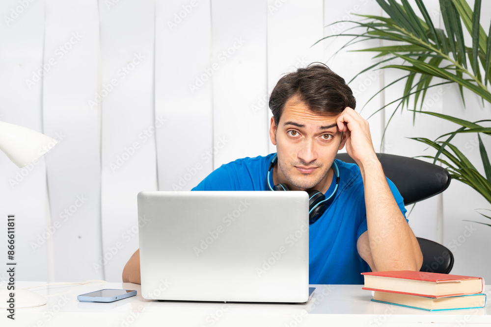 Tired and bored man preparing for exams at university. Stressful education concept Tired and bored man preparing for exams at university. Stressful education concept