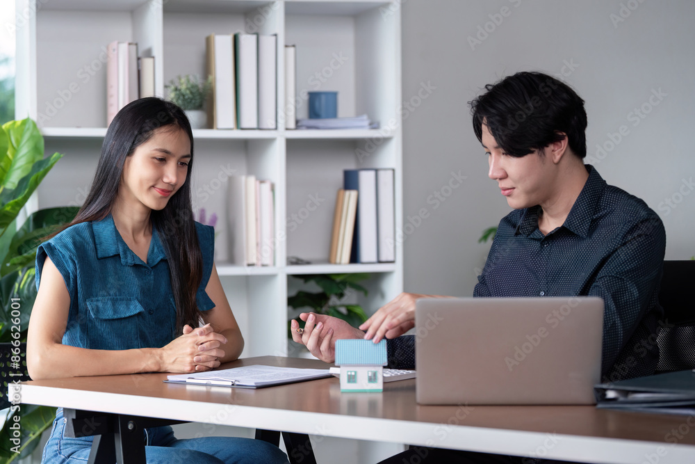 Real Estate Agent and Client Signing Home Purchase Contract in Modern Office Setting Real Estate Agent and Client Signing Home Purchase Contract in Modern Office Setting