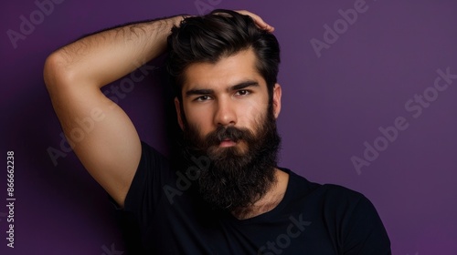 middle aged man with beard looking at camera on purple background