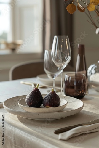 Two Halved Figs on a Speckled Plate With Wine Glasses and Fruit