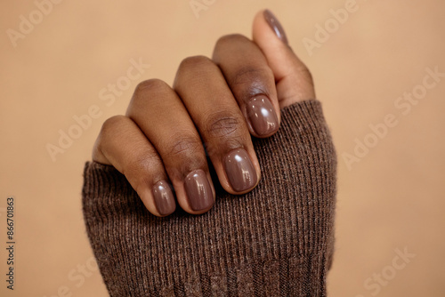 Bild auf Leinwand Close up shot of simple nail design in rich brown shade for autumn complementing