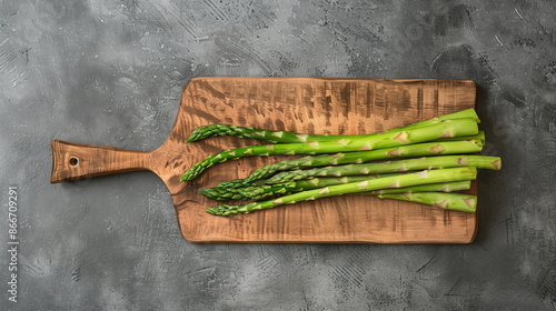 copy space, stockphoto, wooden cutting board with only fresh asparagus, no other vegetables. Healthy food concept. Fresh asparagus poster, design for vegetables store, vetetables department. photo