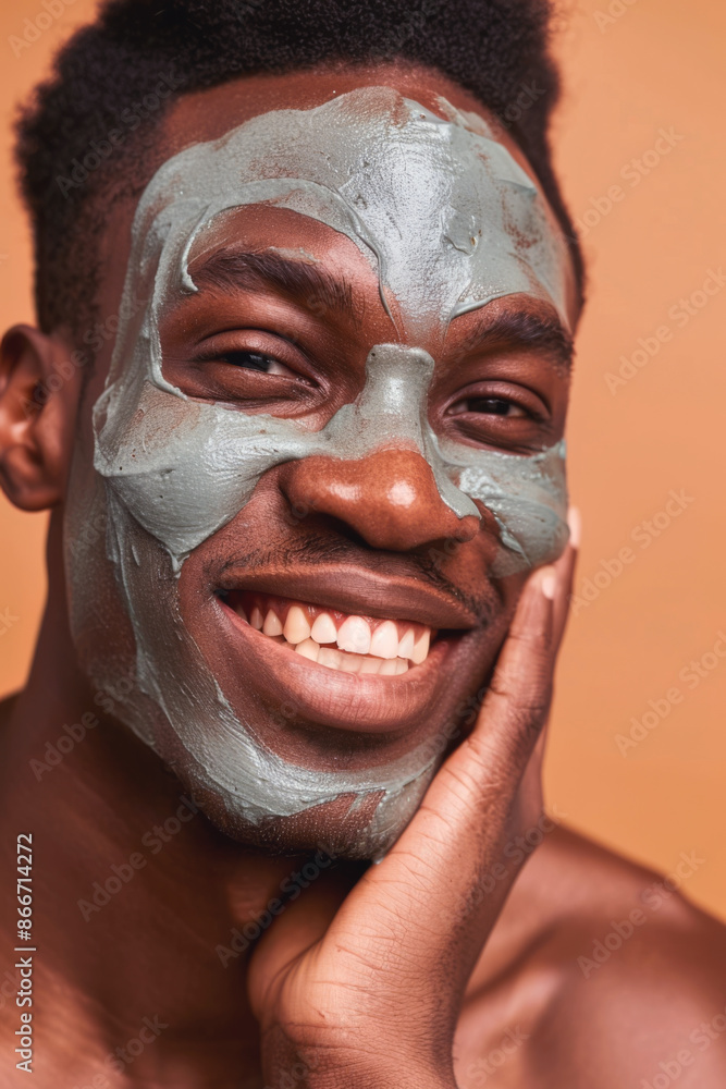 A young African American man laughing with a clay face mask, enjoying a skincare treatment A young African American man laughing with a clay face mask, enjoying a skincare treatment
