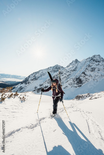 Wallpaper Mural Mountaineer backcountry ski walking ski alpinist in the mountains. Ski touring in alpine landscape with snowy trees. Adventure winter sport. High tatras, Slovakia Torontodigital.ca
