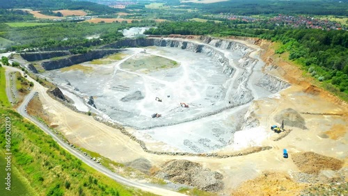 Stone quarry. Open cast mining. Industrial landscape. Heavy industry from above. Aerial view to big source of emissions.
