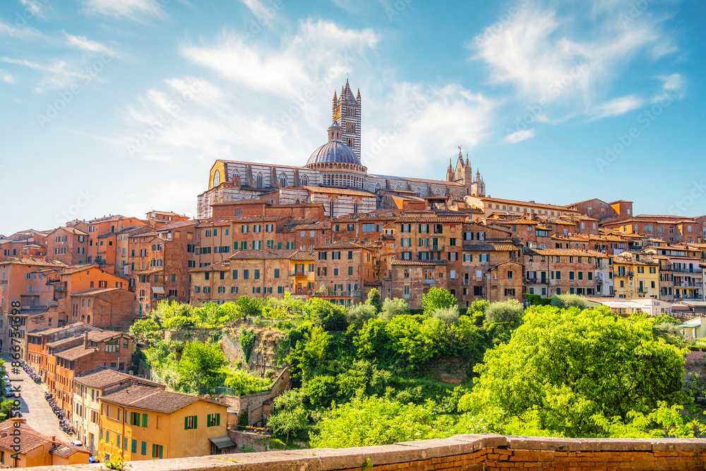 Fototapeta premium Siena, medieval town in Tuscany, with view of the Dome & Bell Tower of Siena Cathedral, Mangia Tower and Basilica of San Domenico, Italy