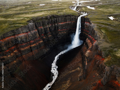 Obraz na płótnie View from above, stunning aerial view of the Hengifoss Waterfall. Hengifoss, is eye-catching due to the striking red clay and black basalt patterns of the cliff face. Fljótsdalshreppur, East Iceland. w salonie
