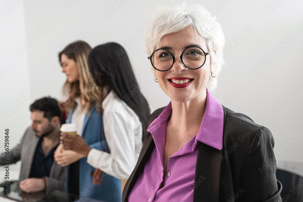 Confident Senior Businesswoman with Team - Leadership and Professionalism in Office Confident Senior Businesswoman with Team - Leadership and Professionalism in Office