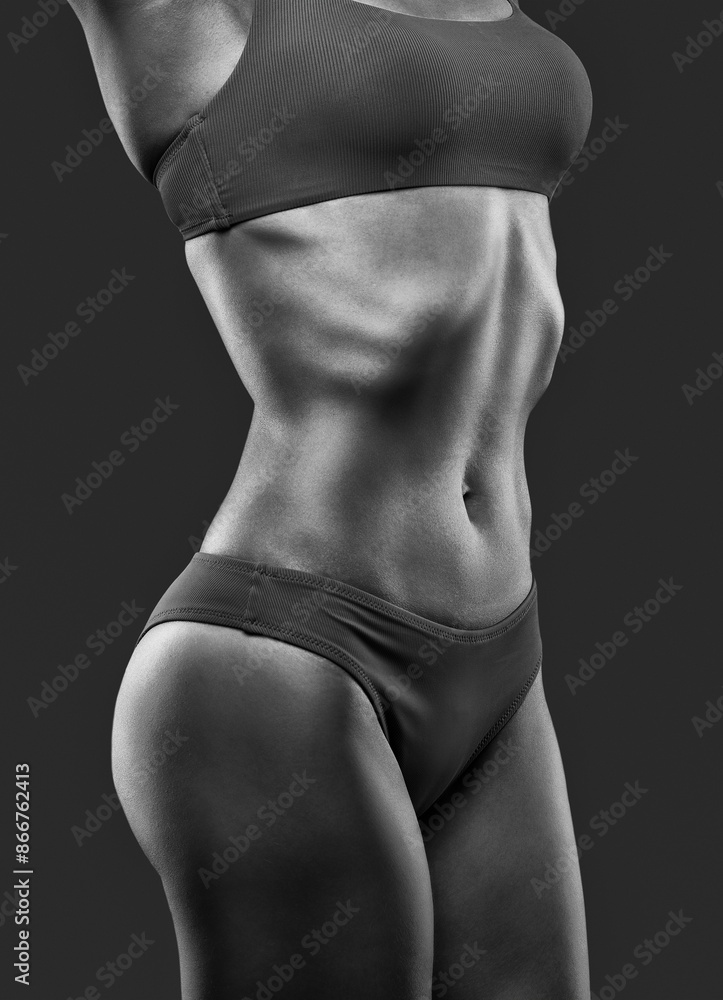 Naklejka premium A young beautiful woman with a slim and muscular figure and dark skin in blue underwear. The concept of weight loss and healthy lifestyle.