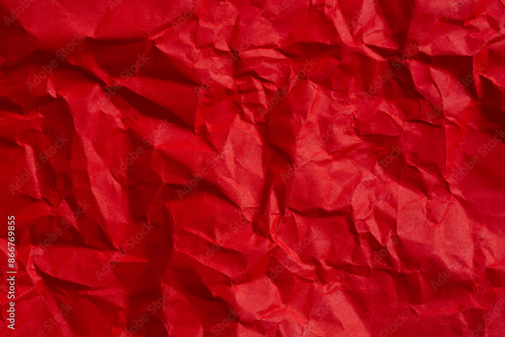 Wrinkled red paper texture,Rectangular crumpled sheet of red paper on a white isolated background Wrinkled red paper texture,Rectangular crumpled sheet of red paper on a white isolated background