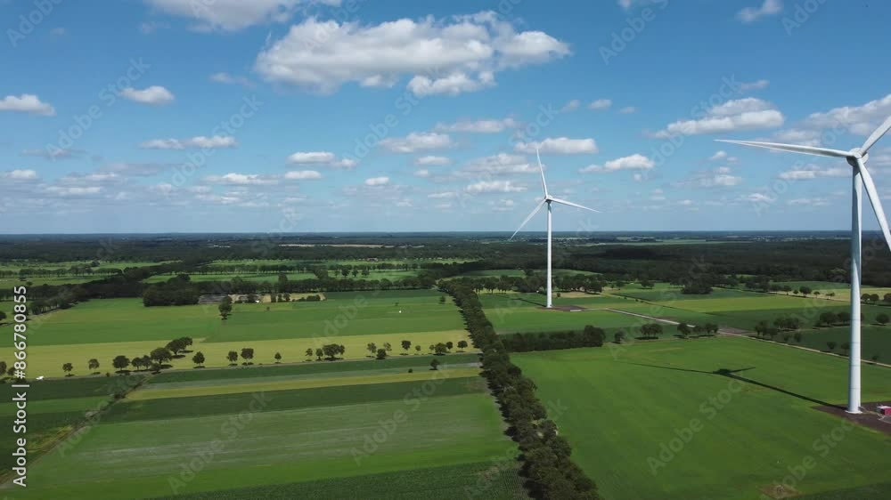 Wind turbines in grassland nature landscape with blue sky captured from above, aerial drone view Wind turbines in grassland nature landscape with blue sky captured from above, aerial drone view