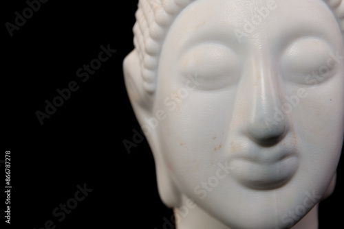 White buddha statue on black background closeup of head © gamerxtc