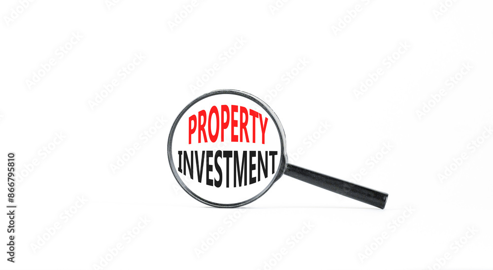 Property investment symbol. Concept words Property investment in beautiful magnifying glass. Beautiful white paper background. Business Property investment concept. Copy space. Property investment symbol. Concept words Property investment in beautiful magnifying glass. Beautiful white paper background. Business Property investment concept. Copy space.