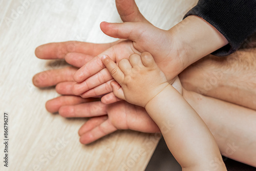 Hands of different generations in a family moment