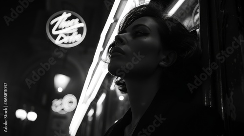 Person standing outside a night establishment with neon lights illuminating the scene, creating a cinematic and moody atmosphere typical of urban night life. photo