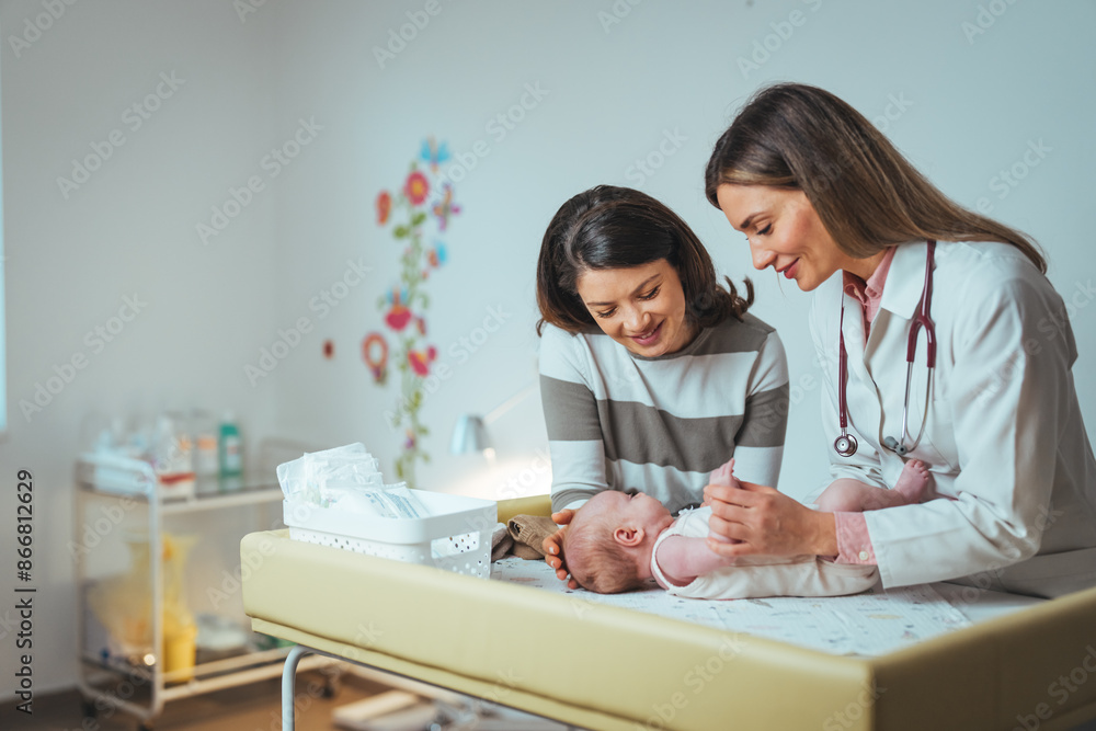 A Caucasian female pediatrician gently examines a newborn, with the mother looking on. Both stand by the infant's hospital crib, surrounded by medical equipment. A Caucasian female pediatrician gently examines a newborn, with the mother looking on. Both stand by the infant's hospital crib, surrounded by medical equipment.