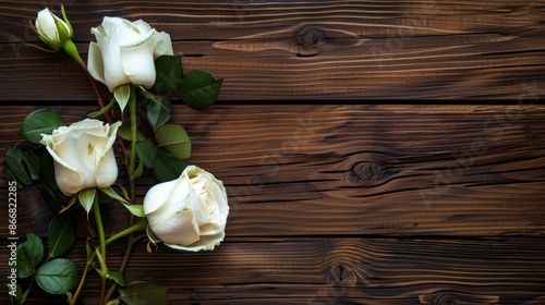 Fototapeta Naklejka Na Ścianę i Meble -  Wooden background with three white roses and space for writing