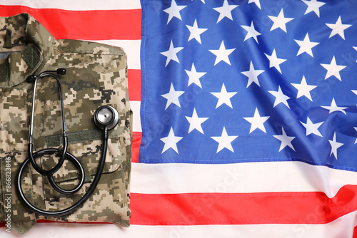 Stethoscope and military uniform on USA flag, top view photo