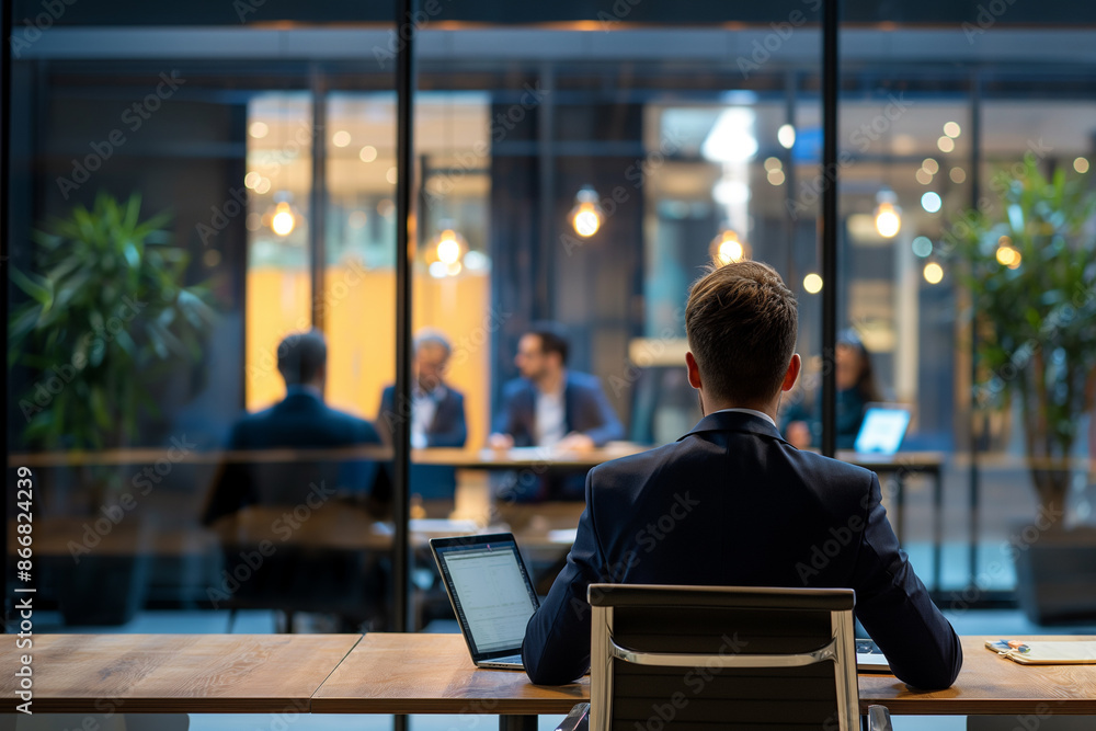 Back view of businessman having meeting with employees in conference room with laptop computer. Back view of businessman having meeting with employees in conference room with laptop computer.