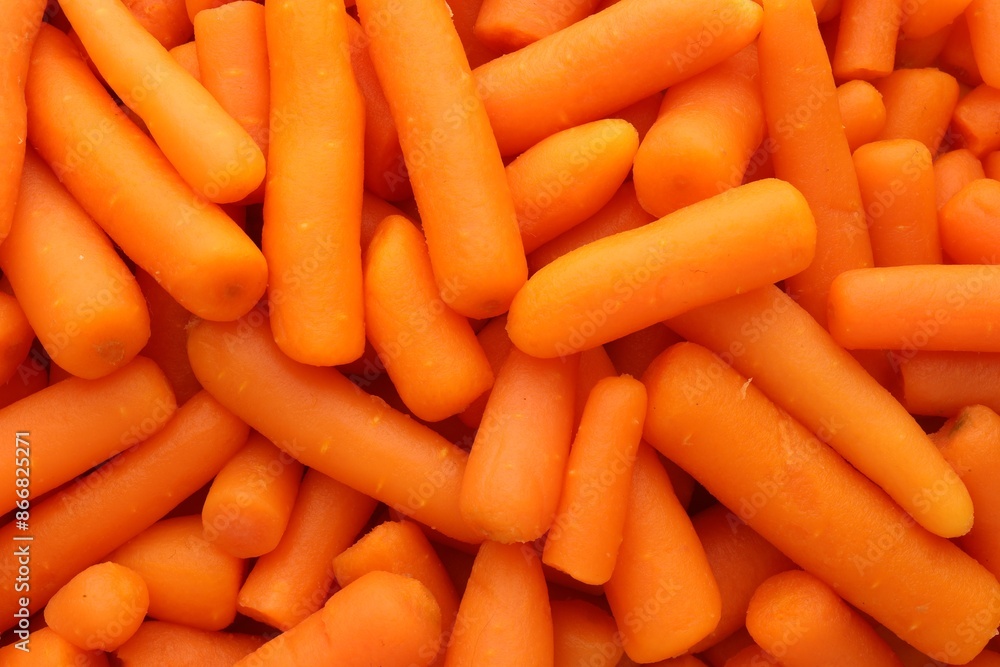 Many baby carrots as background, top view Many baby carrots as background, top view