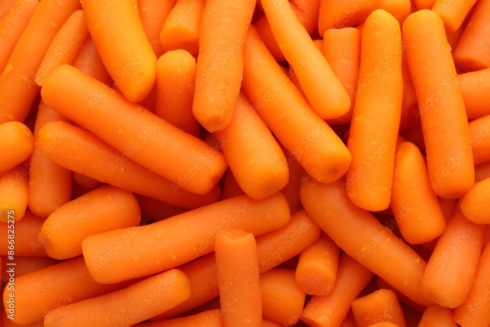 Many baby carrots as background, top view Many baby carrots as background, top view