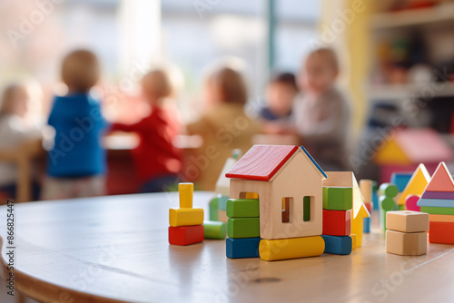 Building bricks toys and blurry playing children in background in children day care center, kindergarten or preschool photo