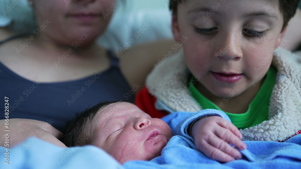 Older sibling lovingly cuddles newborn baby in a heartwarming moment of affection and connection, with mother close by, emphasizing family love and the precious bond between siblings Older sibling lovingly cuddles newborn baby in a heartwarming moment of affection and connection, with mother close by, emphasizing family love and the precious bond between siblings