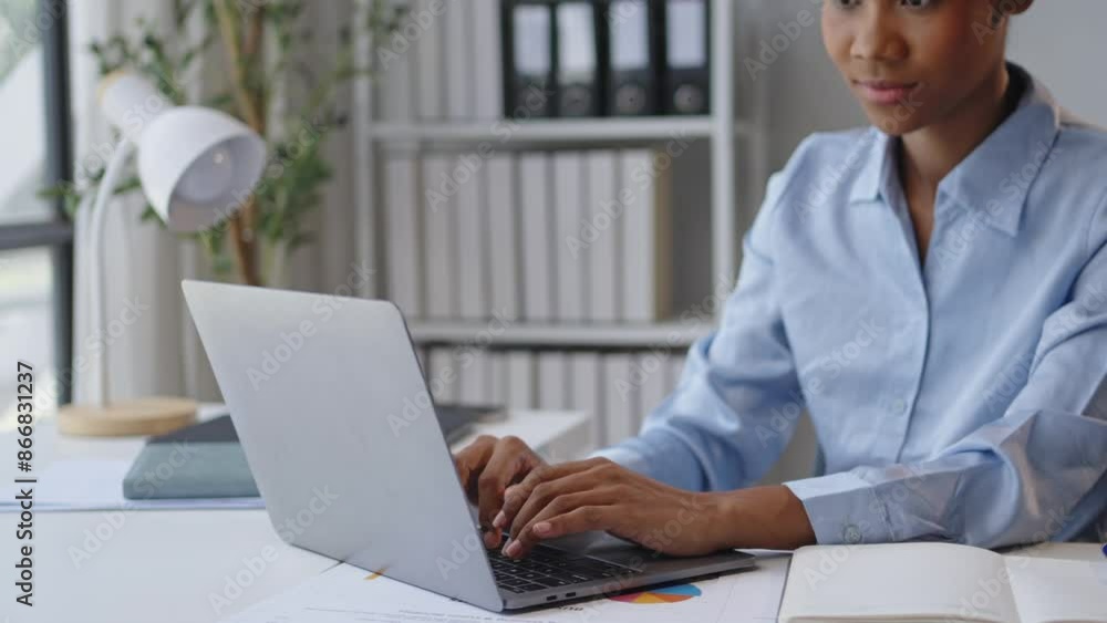 Businesswoman is focused and enthusiastic while working on her laptop in a modern office space. She types, analyzes reports, and smiles, showcasing productivity and professionalism Businesswoman is focused and enthusiastic while working on her laptop in a modern office space. She types, analyzes reports, and smiles, showcasing productivity and professionalism