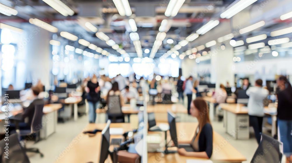 Busy open plan office with workers. Blurred image of a modern open plan office with employees working at their desks. Busy open plan office with workers. Blurred image of a modern open plan office with employees working at their desks.
