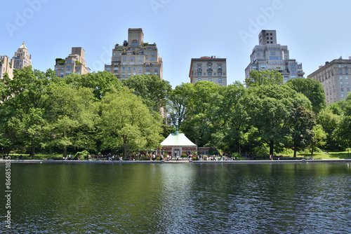 A large body of water with a green tent in the middle. The water is calm and the sky is clear. Central Park NY