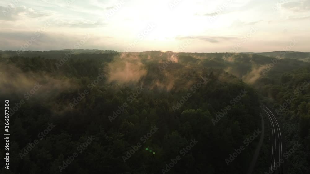 An evening drone flight over a foggy, hazy forest. An evening drone flight over a foggy, hazy forest.
