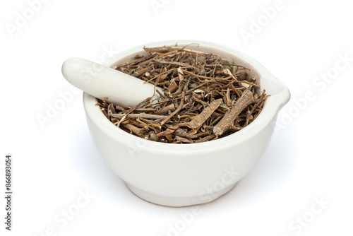 Close-up of Dry Organic Sharpunkha (Tephrosia purpurea) leaves, in white ceramic mortar and pestle, isolated on a white background. photo