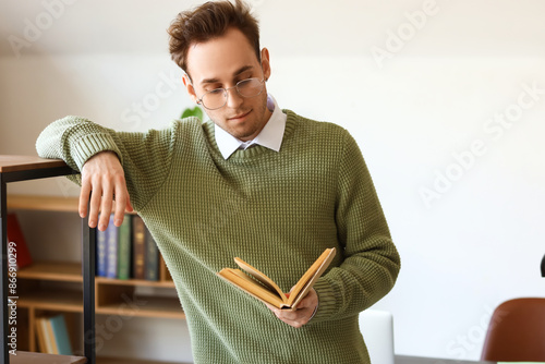 Young man reading book in l...