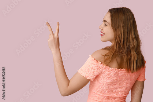 Pretty young woman showing ...