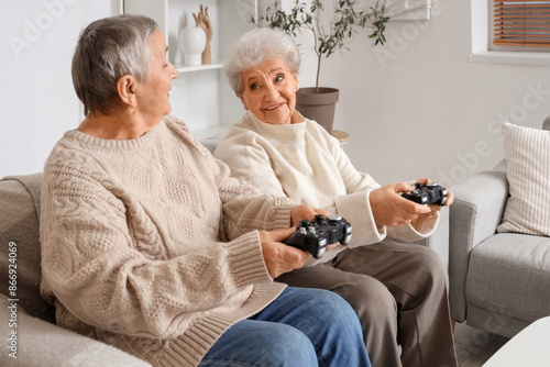 Senior female friends playi...