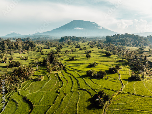 Aerial image of morning golden hour over rice fields and look at mount Agung in Sidemen, Bali, Indonesia photo