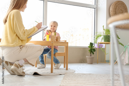 Little girl with toy sittin...