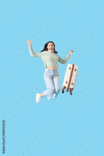 Cheerful female tourist jum...