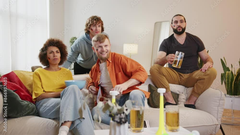 Happy German fans watching football match on tv and drinking beer, cheering for Germany team. European and World football cup 2026, Germany, USA, Canada, Mexico. Sports and soccer fans. Slow Motion Happy German fans watching football match on tv and drinking beer, cheering for Germany team. European and World football cup 2026, Germany, USA, Canada, Mexico. Sports and soccer fans. Slow Motion