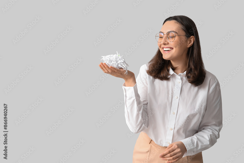 Secretary with shredded paper on light background Secretary with shredded paper on light background