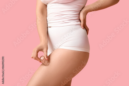 Wallpaper Mural Beautiful young woman with vacuum jar doing massage on pink background, closeup Torontodigital.ca